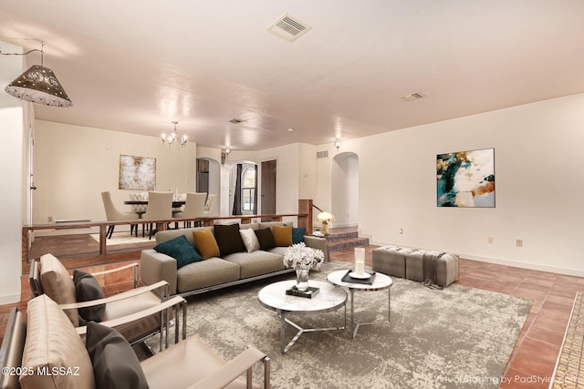 tiled living room featuring an inviting chandelier