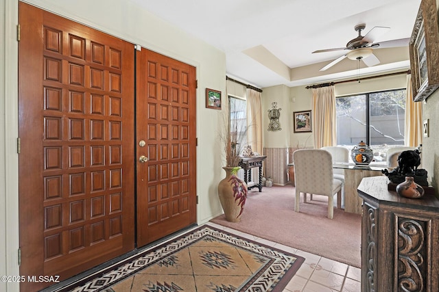 entryway with light carpet and ceiling fan