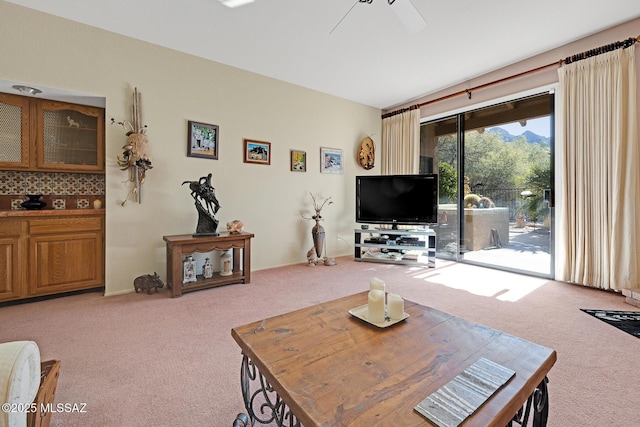 carpeted living room featuring ceiling fan