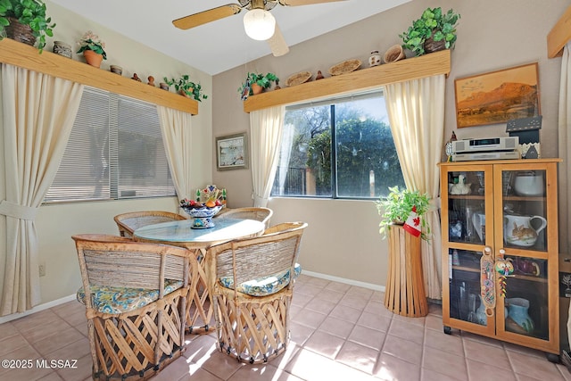 tiled dining area featuring ceiling fan