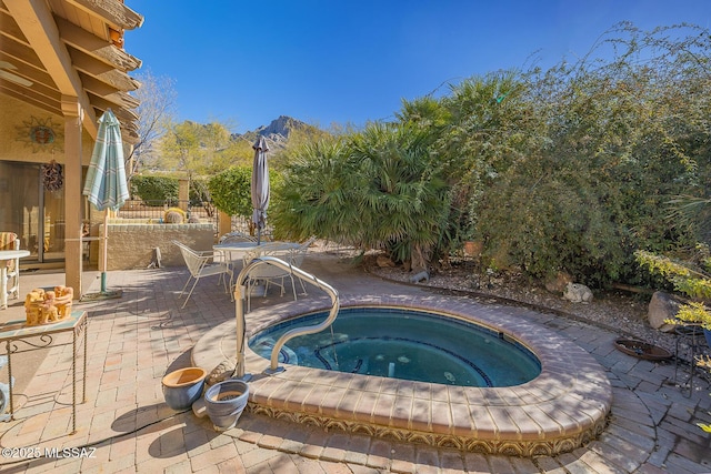 view of pool with an in ground hot tub and a patio area