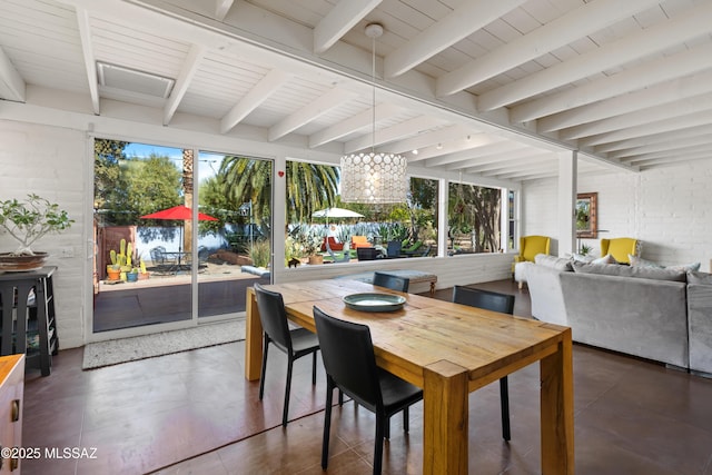 sunroom / solarium featuring beam ceiling and plenty of natural light