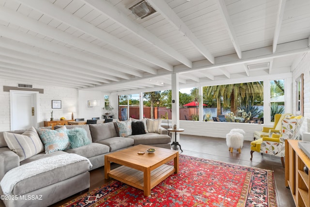 sunroom / solarium featuring a wealth of natural light and beam ceiling