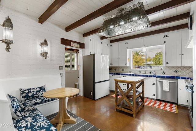 kitchen featuring white cabinetry, backsplash, tile counters, and appliances with stainless steel finishes