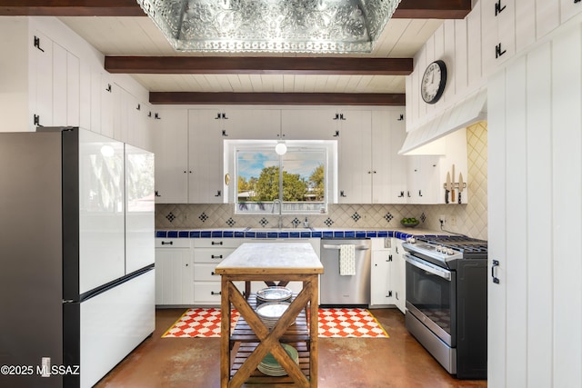 kitchen featuring sink, white cabinetry, beamed ceiling, stainless steel appliances, and backsplash