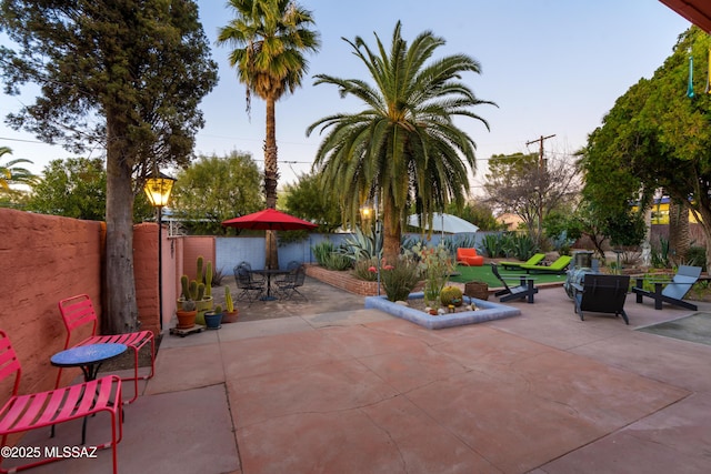 view of patio terrace at dusk