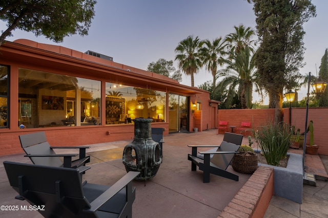 view of patio terrace at dusk