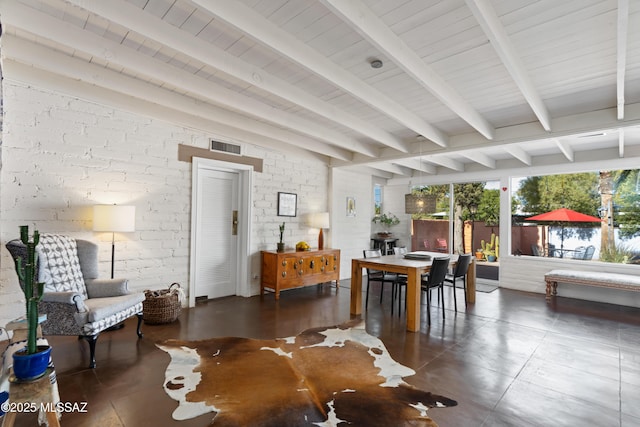 interior space with brick wall and beam ceiling