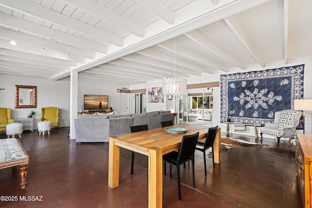 dining area featuring beam ceiling and a chandelier