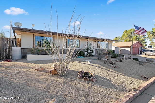 ranch-style house with an outdoor structure and a garage