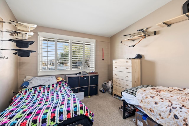 bedroom featuring vaulted ceiling and carpet flooring