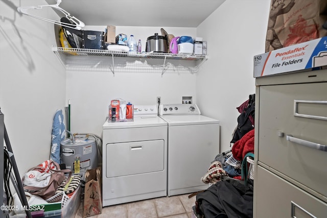 laundry area featuring washing machine and dryer and light tile patterned floors