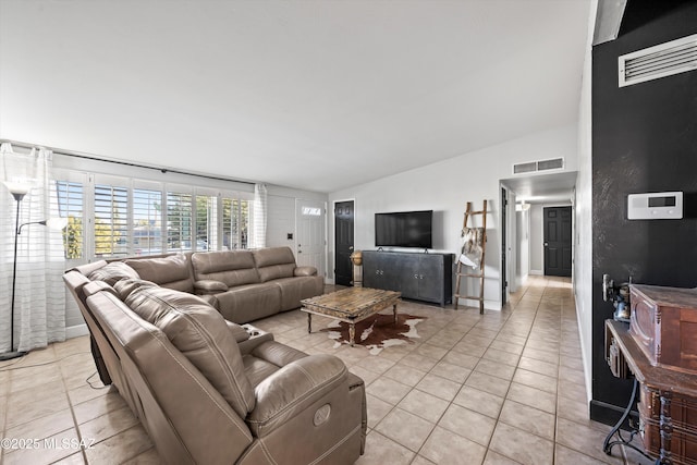 living room featuring light tile patterned floors and vaulted ceiling