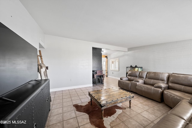 tiled living room featuring brick wall