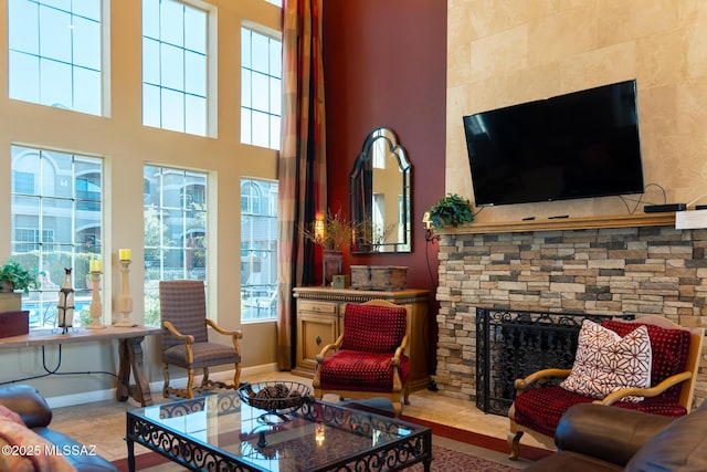 living room with tile patterned flooring and a stone fireplace