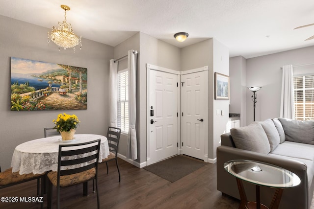 foyer with a chandelier and dark hardwood / wood-style flooring