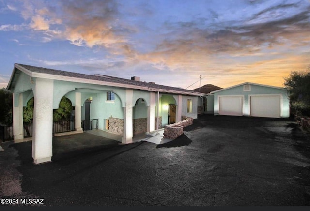 view of front of home with a garage and an outdoor structure