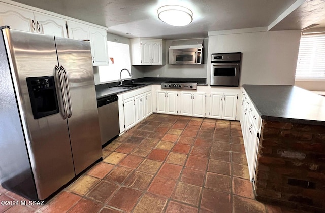 kitchen featuring stainless steel appliances, white cabinets, and sink