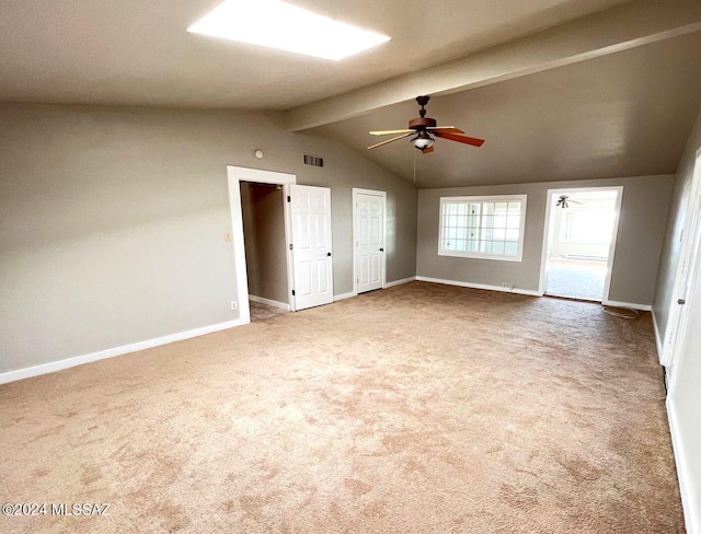 interior space with ceiling fan, lofted ceiling with beams, carpet floors, and two closets