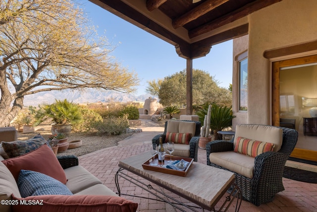 view of patio / terrace with a mountain view and outdoor lounge area