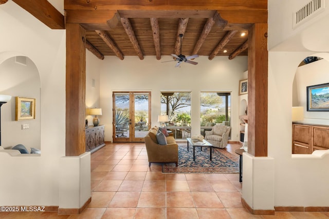 living room featuring beam ceiling, light tile patterned floors, and wood ceiling