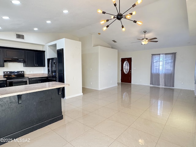 kitchen featuring range with electric cooktop, a kitchen breakfast bar, vaulted ceiling, and black refrigerator