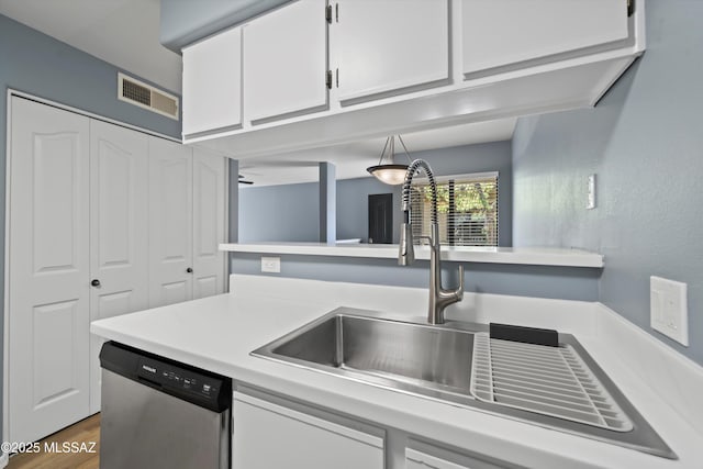 kitchen featuring white cabinets, sink, dark hardwood / wood-style floors, ceiling fan, and stainless steel dishwasher