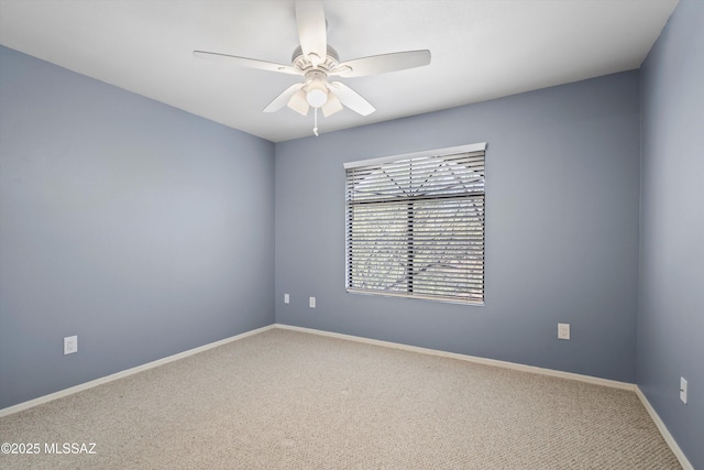 unfurnished room with ceiling fan and carpet floors