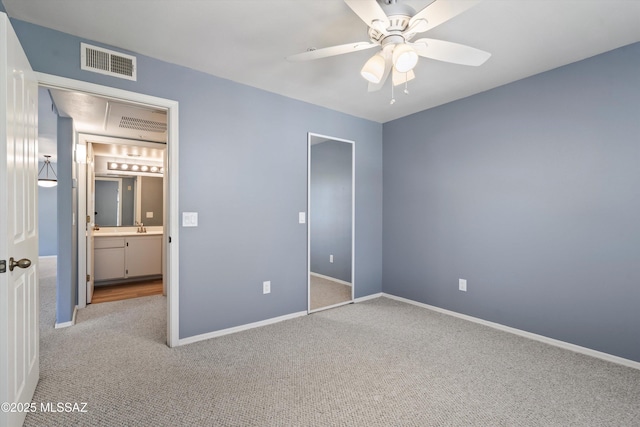 unfurnished bedroom featuring ceiling fan, light colored carpet, and sink