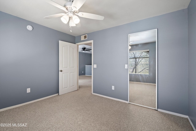 unfurnished bedroom with ceiling fan, a closet, and carpet flooring