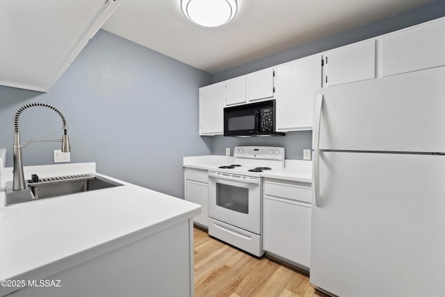 kitchen featuring white cabinetry, sink, light hardwood / wood-style floors, and white appliances