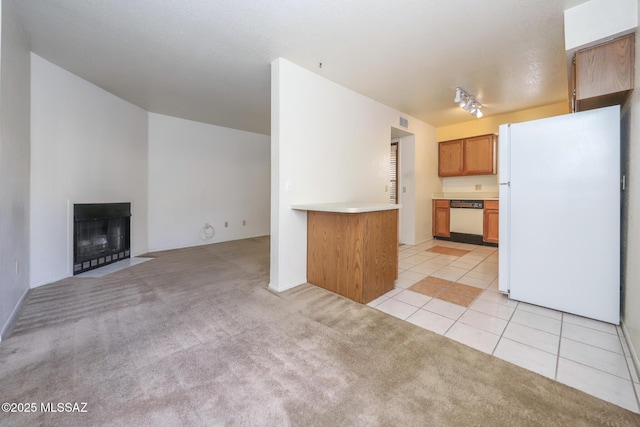 kitchen featuring white appliances, rail lighting, and light tile patterned floors