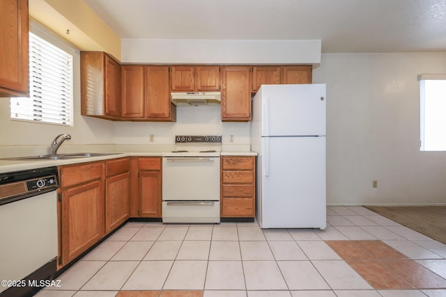 kitchen featuring white appliances, sink, and light tile patterned floors