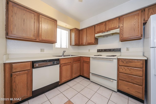 kitchen featuring sink, white appliances, and light tile patterned flooring