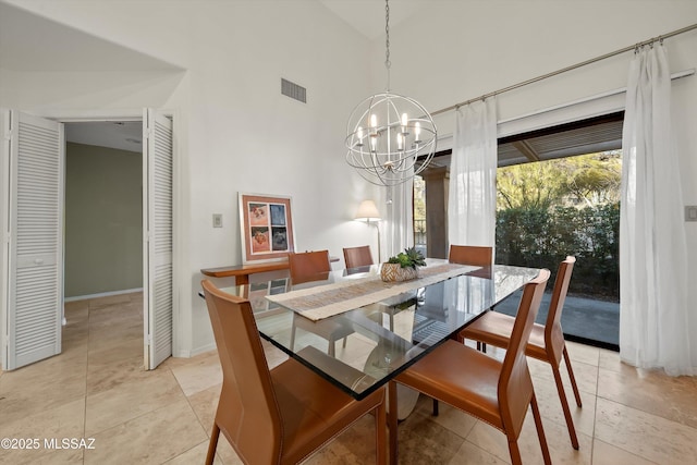 tiled dining space with high vaulted ceiling and a chandelier