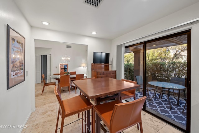 tiled dining area with an inviting chandelier