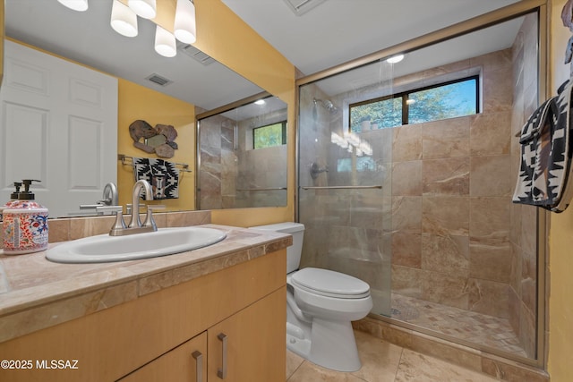 bathroom featuring toilet, an enclosed shower, and vanity