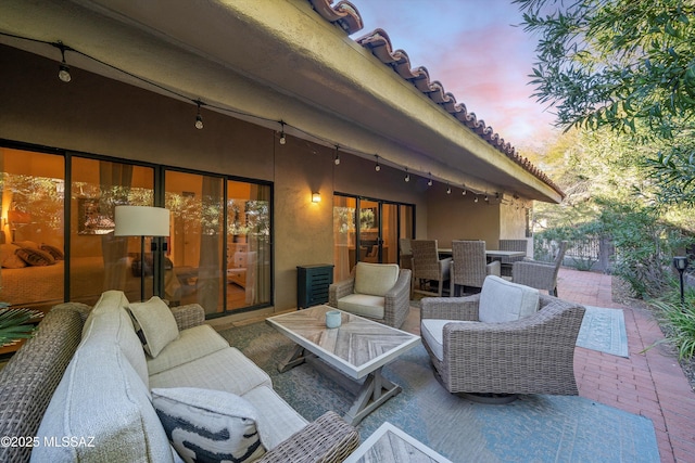 patio terrace at dusk with an outdoor hangout area