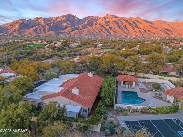 aerial view at dusk featuring a mountain view