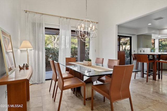 dining area featuring a chandelier and light tile patterned flooring