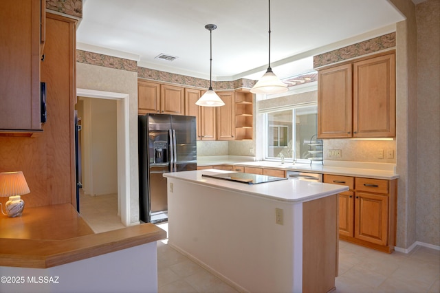 kitchen with appliances with stainless steel finishes, sink, a kitchen island, decorative light fixtures, and ornamental molding