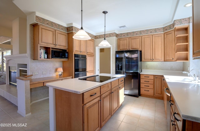 kitchen featuring black appliances, light tile patterned floors, sink, a kitchen island, and decorative light fixtures