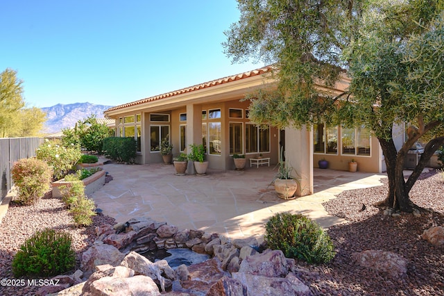 1845 E Mellow Trl, Oro Valley, AZ 85755 - rear view of house with fence, a patio area, a mountain view, stucco siding, and a tile roof