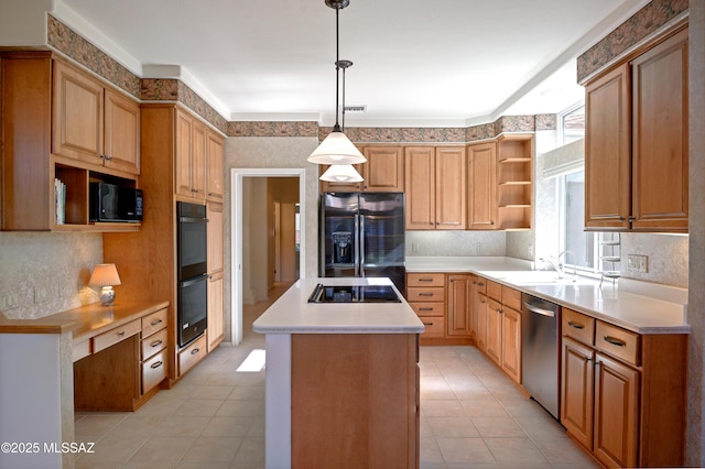 kitchen featuring decorative light fixtures, sink, light tile patterned floors, a kitchen island, and black appliances