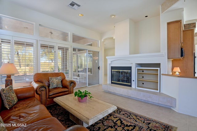 tiled living room with a tiled fireplace