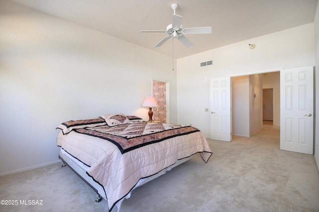 bedroom with ceiling fan and light carpet