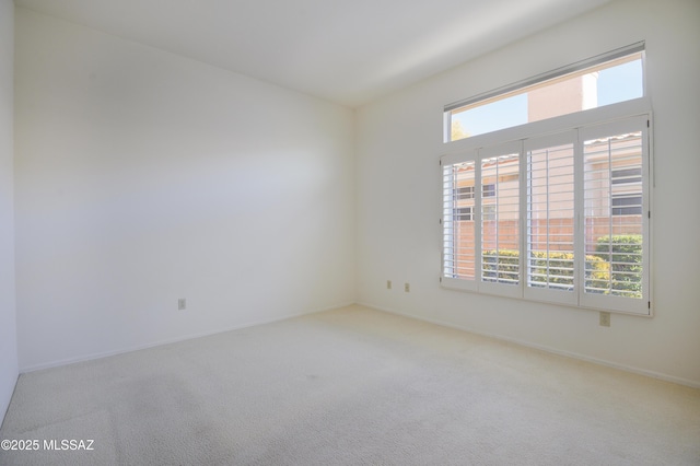 spare room featuring carpet floors and a wealth of natural light