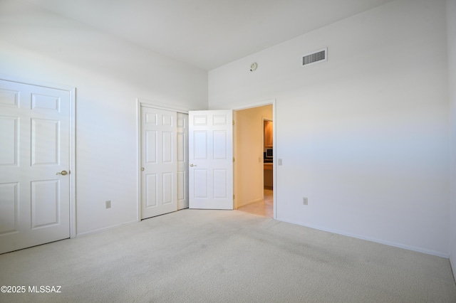 unfurnished bedroom featuring light colored carpet