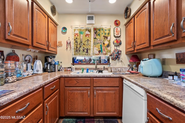 kitchen featuring white dishwasher and sink