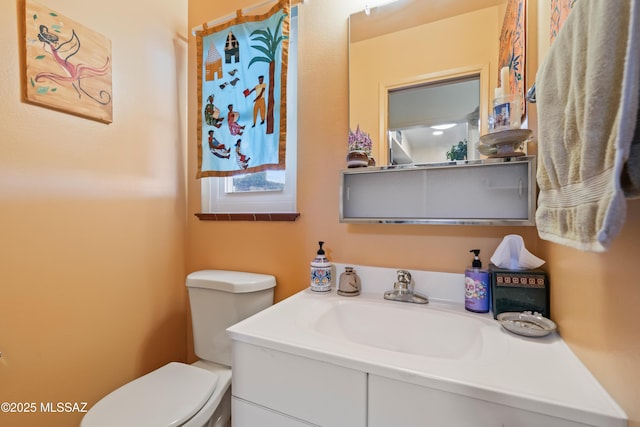 bathroom with toilet and vanity